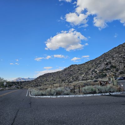 Mountain road with blue sky and clouds.