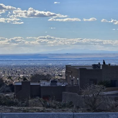 Desert landscape with mountains and scattered buildings.