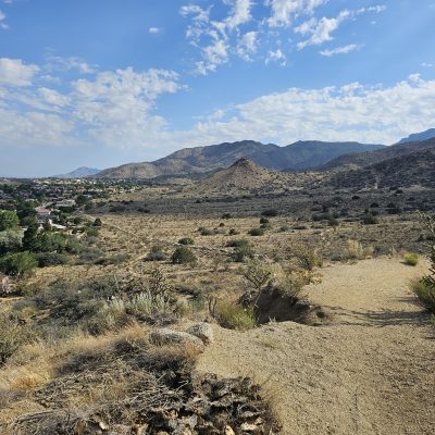 Desert landscape with mountains and distant town.