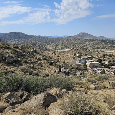 Desert town surrounded by rocky hills and mountains.
