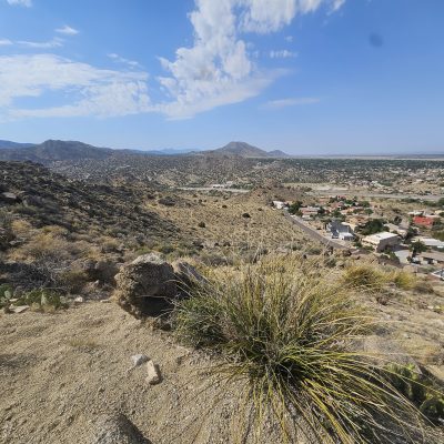 Scenic desert landscape with mountain and town view.
