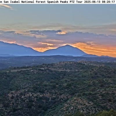 Sunset over Spanish Peaks in Colorado forest